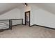 Attic space features neutral carpet, white walls, and black trim, with a railing overlooking below at 2828 N Illinois St, Indianapolis, IN 46208