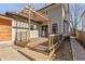 Wooden backyard deck with pergola, black railings, and a sliding glass door entrance at 2828 N Illinois St, Indianapolis, IN 46208