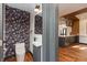 Powder room with patterned wallpaper and wood floors visible from the kitchen at 2828 N Illinois St, Indianapolis, IN 46208