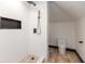 Tiled shower with black fixtures and a toilet in an all-white bathroom at 2828 N Illinois St, Indianapolis, IN 46208
