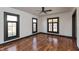 Inviting bedroom features hardwood floors, white walls, black window trim and ample natural light throughout at 2828 N Illinois St, Indianapolis, IN 46208