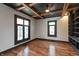 A bright bedroom featuring large windows, hardwood floors, and custom built-in shelving at 2828 N Illinois St, Indianapolis, IN 46208