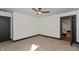 Bedroom with carpeted floors, bright windows, and a view to the stairwell at 2828 N Illinois St, Indianapolis, IN 46208