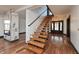 Bright entryway showcasing floating stairs with wooden treads and an accent fireplace with marble surround at 2828 N Illinois St, Indianapolis, IN 46208