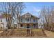Beautiful two-story home with inviting front porch, landscaped stairs, and neutral siding against a blue sky at 2828 N Illinois St, Indianapolis, IN 46208