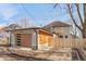 Backyard view of detached two-car garage featuring wood paneling, modern lights, and wooden fence at 2828 N Illinois St, Indianapolis, IN 46208