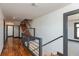 Hallway with hardwood floors leading to a stairway and gray door frames at 2828 N Illinois St, Indianapolis, IN 46208