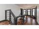 Bright hallway features hardwood floors, modern railing, and lots of natural light from the large windows at 2828 N Illinois St, Indianapolis, IN 46208