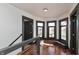 Bright hallway features hardwood floors, bench seat, and lots of natural light from the large windows at 2828 N Illinois St, Indianapolis, IN 46208