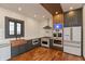 Modern kitchen featuring stainless steel appliances, copper accents, and wood floors at 2828 N Illinois St, Indianapolis, IN 46208