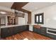 A modern kitchen with stainless steel appliances, stone countertops, and hardwood floors at 2828 N Illinois St, Indianapolis, IN 46208