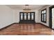 A spacious living room featuring large windows, hardwood floors, and a modern chandelier at 2828 N Illinois St, Indianapolis, IN 46208