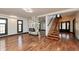Spacious living room featuring wood floors, black trim, an accent fireplace, and ample natural light at 2828 N Illinois St, Indianapolis, IN 46208