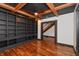 A modern office with custom built-in shelving, hardwood floors, and wooden ceiling beams at 2828 N Illinois St, Indianapolis, IN 46208