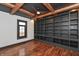 A modern office with custom built-in shelving, hardwood floors, and a ceiling fan at 2828 N Illinois St, Indianapolis, IN 46208