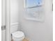 Bathroom featuring toilet, white walls and a window at 2829 Country Estates Dr, Indianapolis, IN 46227