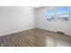 Bright, empty bedroom with a window and wood-look flooring at 2829 Country Estates Dr, Indianapolis, IN 46227