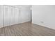 Empty bedroom with a closet, wood-look flooring, and view into the hall at 2829 Country Estates Dr, Indianapolis, IN 46227