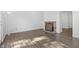 Bright living room with fireplace, built in shelves, and wood-look flooring at 2829 Country Estates Dr, Indianapolis, IN 46227