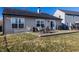 Backyard features a patio with a table, outdoor seating, grill, and grassy lawn at 3037 Knobstone Ln, Indianapolis, IN 46203