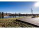 Backyard features a pond with fence, grassy area, and patio seating with a table at 3037 Knobstone Ln, Indianapolis, IN 46203