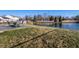 Backyard features a pond with fence, grassy area, and outdoor seating with a table at 3037 Knobstone Ln, Indianapolis, IN 46203