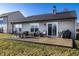 Backyard features a patio with a table, outdoor seating, grill, and well-kept lawn at 3037 Knobstone Ln, Indianapolis, IN 46203