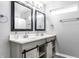 Contemporary bathroom featuring a double vanity with framed mirrors and grey cabinets at 3037 Knobstone Ln, Indianapolis, IN 46203