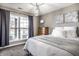 Cozy bedroom featuring a large window, warm colors, dresser, and accents at 3037 Knobstone Ln, Indianapolis, IN 46203