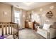 Bright Bedroom features neutral walls, window, crib, dresser, chair, and decorative flower decals at 3037 Knobstone Ln, Indianapolis, IN 46203