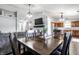 Open concept dining area with wood table and chairs, flowing into living room and kitchen at 3037 Knobstone Ln, Indianapolis, IN 46203