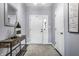 Inviting entryway with console table, decorative mirror, and a view of the front door at 3037 Knobstone Ln, Indianapolis, IN 46203
