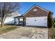 Single-Gathering home with a brick facade, well-manicured lawn, and a two-car garage at 3037 Knobstone Ln, Indianapolis, IN 46203