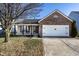 Charming single-Gathering home showcasing a brick facade and two-car garage at 3037 Knobstone Ln, Indianapolis, IN 46203