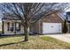 Single-Gathering home featuring a well-maintained lawn, brick accents, and an attached garage at 3037 Knobstone Ln, Indianapolis, IN 46203
