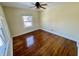 A bright bedroom is well-lit by natural light from two windows and features hardwood floors at 3236 Central Ave, Indianapolis, IN 46205