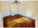 A light-filled bedroom with hardwood floors has two entry doors and a ceiling fan at 3236 Central Ave, Indianapolis, IN 46205