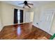 Spacious bedroom with hardwood floors, natural light, and an open doorway at 3236 Central Ave, Indianapolis, IN 46205