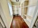 A walk-in closet offers ample shelving and hanging space, illuminated by a window for natural light at 3236 Central Ave, Indianapolis, IN 46205