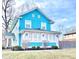 Charming two-story turquoise home with a bright sunroom and beautifully landscaped front yard at 3236 Central Ave, Indianapolis, IN 46205