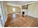 Open-concept living room with hardwood floors and a fireplace at 3236 Central Ave, Indianapolis, IN 46205