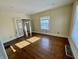 Bright living room with hardwood floors, white trim and several windows for abundant natural light at 3236 Central Ave, Indianapolis, IN 46205