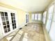 Sunny sunroom with tiled floors and multiple windows at 3236 Central Ave, Indianapolis, IN 46205