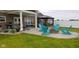 Backyard patio featuring Adirondack chairs around firepit and pergola with outdoor dining at 3629 S Meadows Ln, New Palestine, IN 46163