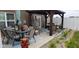 Covered patio with outdoor dining area and wicker furniture at 3629 S Meadows Ln, New Palestine, IN 46163