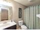 Bathroom featuring vanity with framed mirror and shower with patterned curtain at 3629 S Meadows Ln, New Palestine, IN 46163