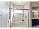 Bathroom showcasing a tiled walk-in shower with a glass door, a built-in bench, and chrome fixtures at 3629 S Meadows Ln, New Palestine, IN 46163