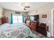 Comfortable bedroom features wood furniture, ceiling fan, and natural light from the window at 3629 S Meadows Ln, New Palestine, IN 46163