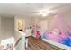 View of bedroom with fun decor, hardwood floors and white trim at 3629 S Meadows Ln, New Palestine, IN 46163