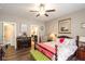 Comfortable bedroom features wood furniture, ceiling fan, and view into the ensuite bathroom at 3629 S Meadows Ln, New Palestine, IN 46163